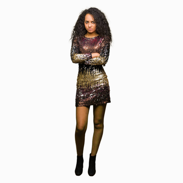 Young beautiful girl with curly hair wearing night party dress skeptic and nervous, disapproving expression on face with crossed arms. Negative person. - Photo, image