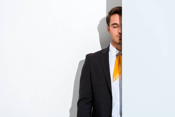 cropped view of stylish man with closed eyes on white  - Foto, imagen