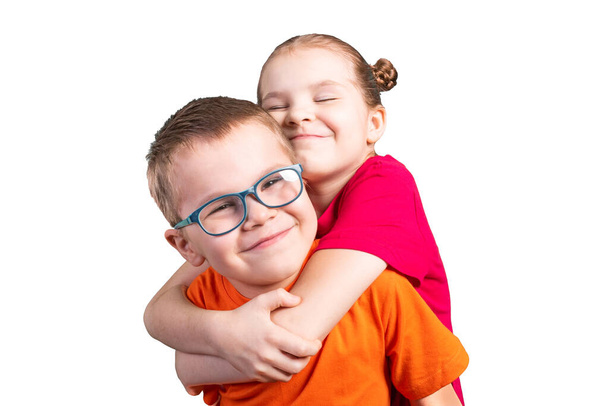 Brother and sister hugging and smiling. Isolated on a white background. - Foto, imagen