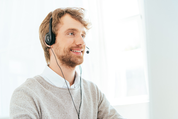 handsome bearded operator in brokers agency in headset  - Photo, Image
