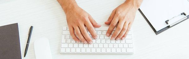 panoramic shot of broker typing on computer keyboard in office  - 写真・画像
