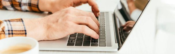 panoramic shot of broker typing on laptop keyboard in office  - Фото, зображення