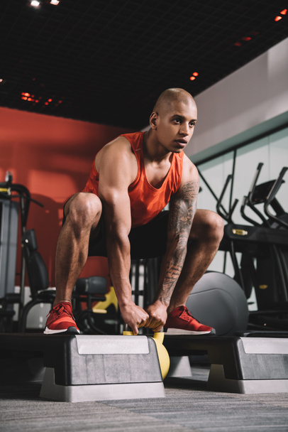 young african american sportsman lifting weight in gym - Φωτογραφία, εικόνα