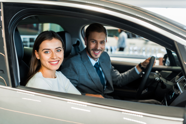 selective focus of pretty woman sitting in car with man  - Photo, Image