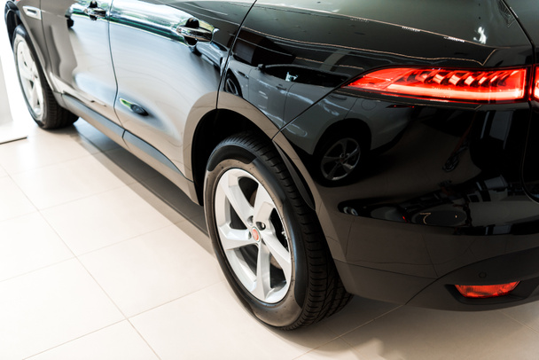 black and luxury car in car showroom   - Фото, изображение
