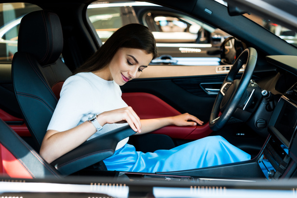 pretty woman sitting in new modern car  - Zdjęcie, obraz