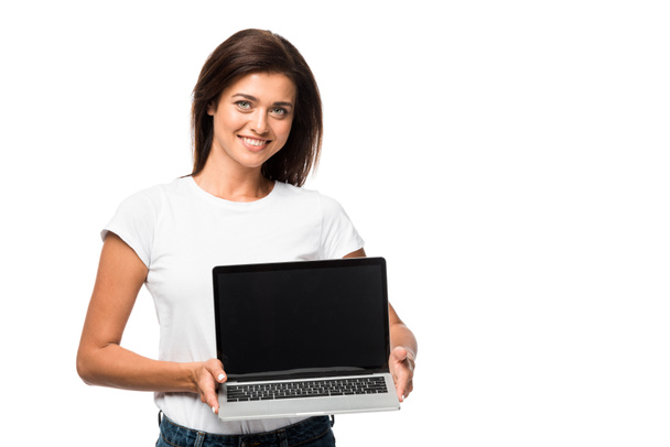 beautiful smiling woman showing laptop with blank screen, isolated on white - Foto, Imagem