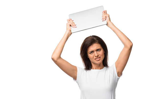 beautiful stressed girl holding laptop, isolated on white - Photo, Image
