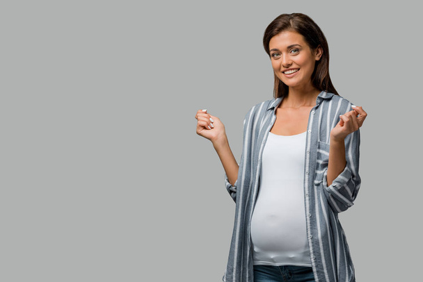 schöne fröhliche schwangere Frau posiert isoliert auf grau - Foto, Bild