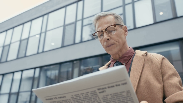 Geschäftsmann liest Zeitung und trinkt Kaffee  - Filmmaterial, Video