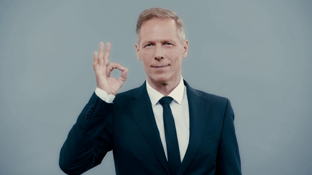 smiling businessman in suit showing ok gesture  - Video, Çekim