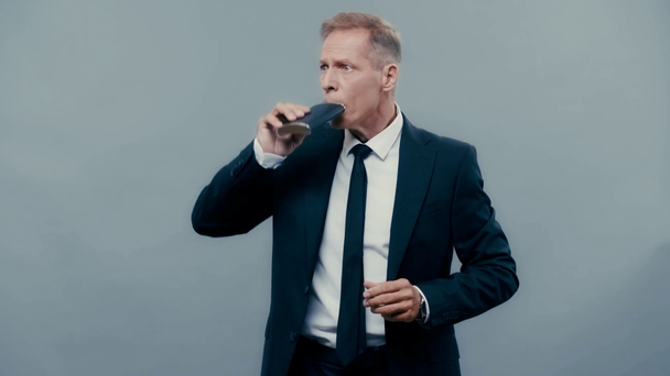 businessman drinking from flask and showing shh  - Footage, Video