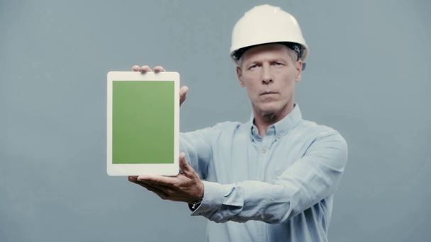 architect in helmet showing digital tablet with blank screen - Filmagem, Vídeo