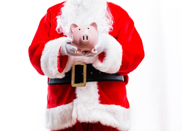 Santa holding a piggy bank - Foto, immagini