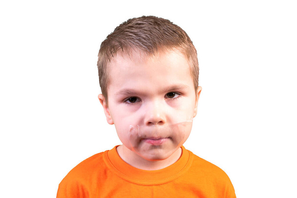 Boy with a closed mouth. Isolated on a white background. - Photo, Image