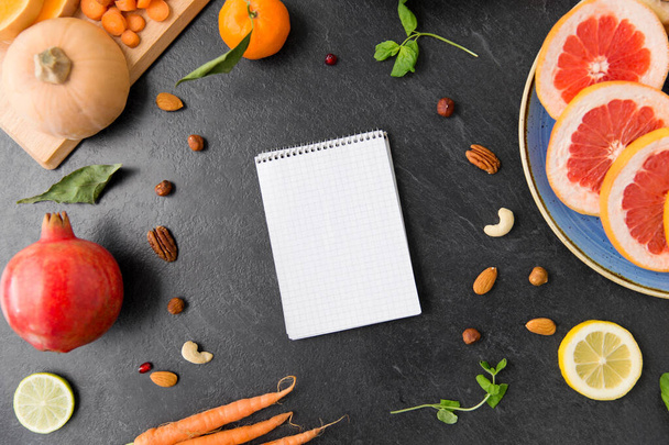 close up of notebook, fruits and vegetables - Photo, image