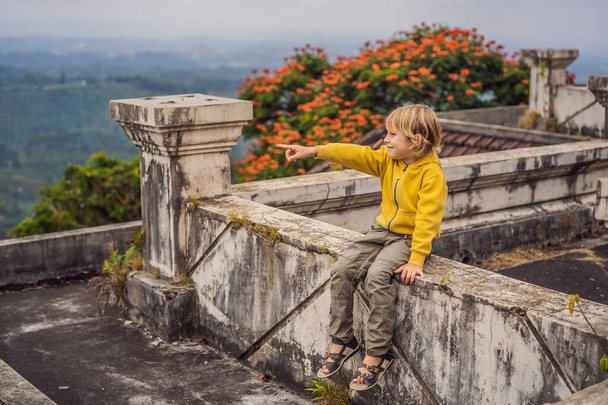 Tourist boy in abandoned and mysterious hotel in Bedugul. Indonesia, Bali Island. Bali Travel Concept - Photo, Image