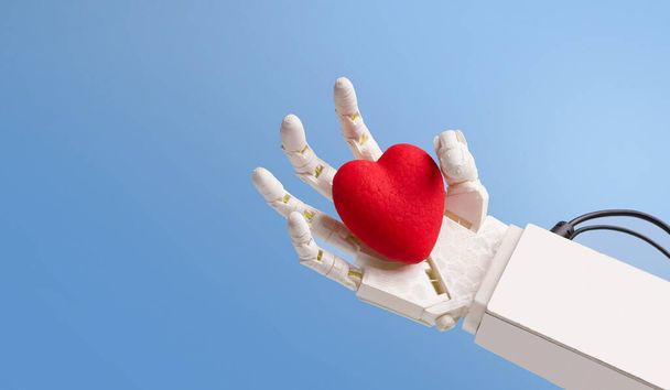 Red heart in robot hand, blue panorama background - Φωτογραφία, εικόνα