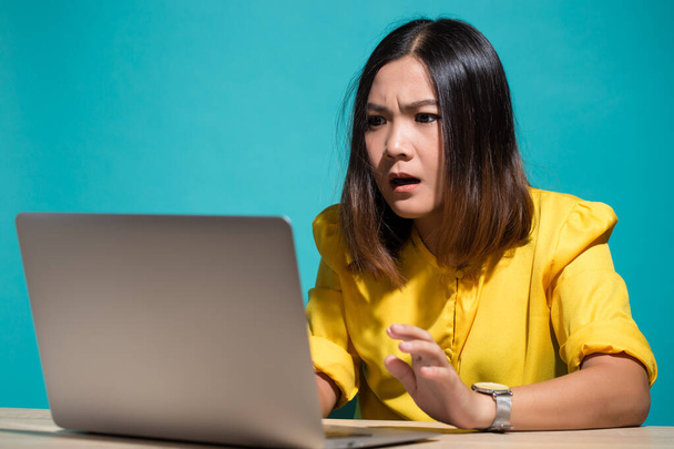 Woman has shock when she look at laptop - Photo, Image