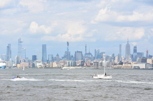 NEW YORK, NY - AUG 4: View of Manhattan Skyline, from Liberty State Park in Jersey City, New Jersey, as seen on Aug 4, 2019. Manhattan is the most densely populated of the five boroughs of New York City. - Photo, image
