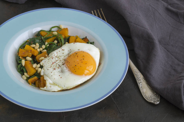 Sunny side up egg with spinach and pumpkin. - Photo, Image