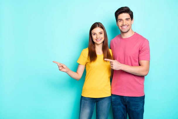 Portrait of his he her she nice attractive lovely cheerful cheery content couple hugging pointing aside ad advert solution isolated over bright vivid shine vibrant green turquoise background - Foto, Imagem