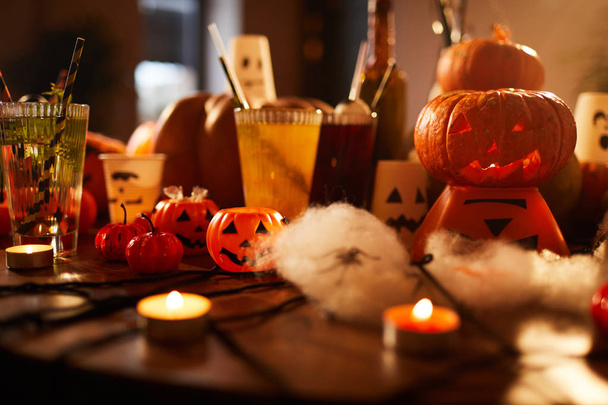 Halloween background of witches table with candles and pumpkins decorations set for party in nightclub, copy space - Photo, Image