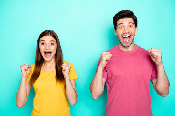 Portrait of his he her she nice attractive lovely glad cheerful cheery couple celebrating attainment good news isolated over bright vivid shine vibrant green blue turquoise background - Foto, Imagen