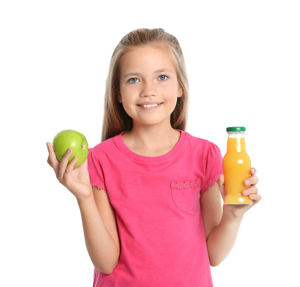 Happy girl holding apple and bottle of juice on white background. Healthy food for school lunch - Foto, Imagen
