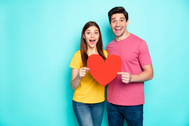 Portrait of his he her she nice attractive lovely amazed cheerful cheery couple hugging holding in hands big large heart symbol isolated over bright vivid shine vibrant green turquoise background - Photo, Image