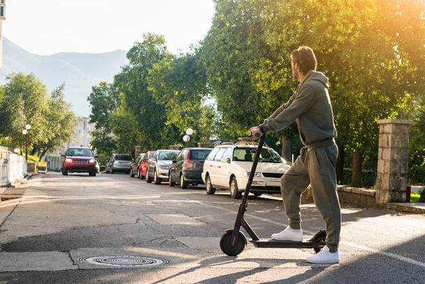 A man with electric scooter on the street - Zdjęcie, obraz