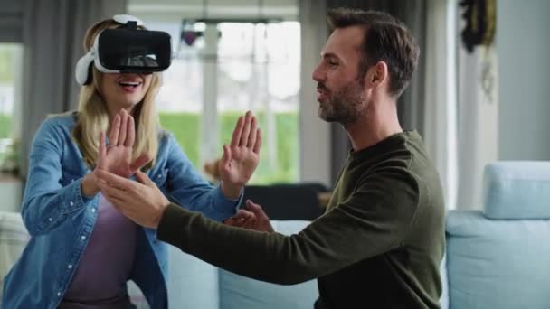Modern couple using virtual reality simulator - Materiał filmowy, wideo