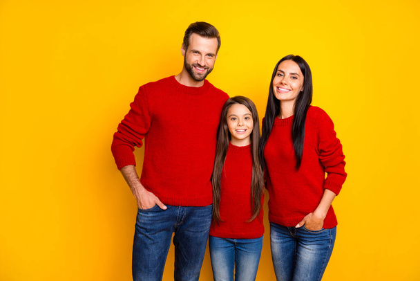 Photo of cute nice happy enjoying family standing confidently in jeans denim with hands in pockets smiling toothily man bearded woman attractive isolated over vivid yellow color background - Foto, Bild