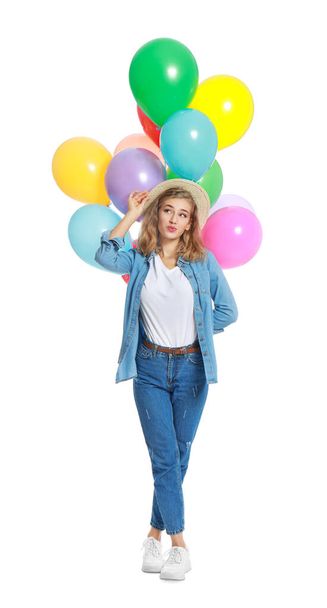 Emotional young woman holding bunch of colorful balloons on white background - Foto, Imagem