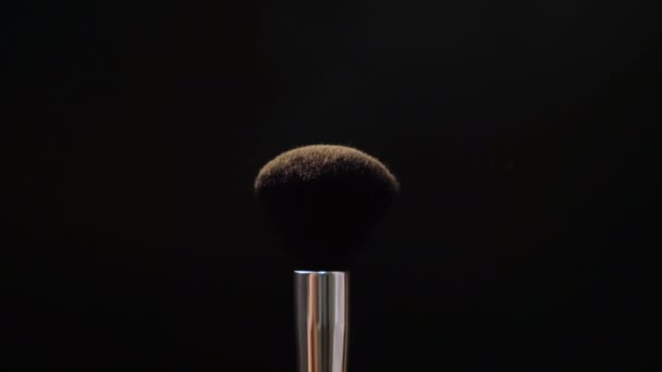Two black makeup brushes with powder or blush on a dark background. Beauty concept - Πλάνα, βίντεο