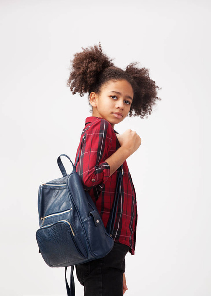 Cute smiley girl in chequered shirt with backpack  - Foto, Bild