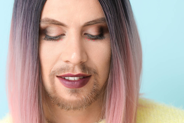 Portrait of young transgender woman on color background - Foto, imagen