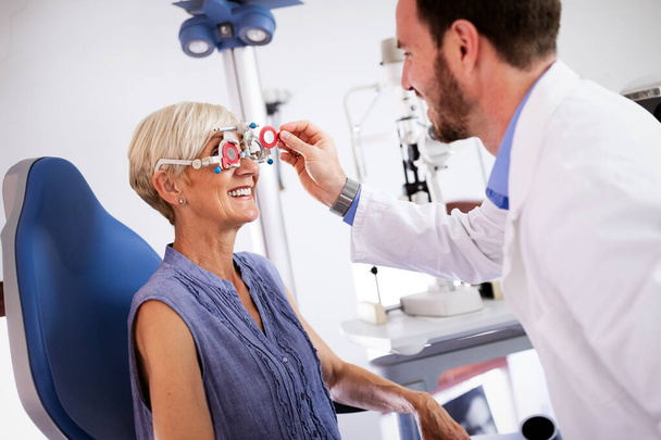 Ophthalmology concept. Senior woman eye vision examination in ophthalmological clinic - Fotoğraf, Görsel