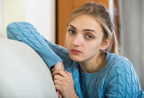 Upset girl in pullover feeling lonely at home - Photo, image