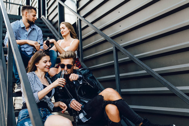 friends, students are having fun and drinking champagne in front - Fotoğraf, Görsel