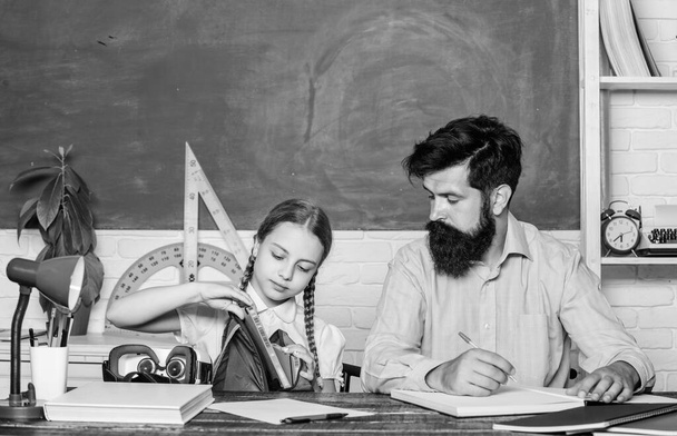 what is insedi. daughter study with father. Teachers day. knowledge day. Home schooling. back to school. Private teaching. small girl child with bearded teacher man in classroom. private lesson - Zdjęcie, obraz