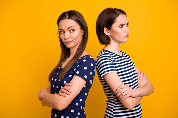 Profile photo of two amazing ladies in bad mood had fight not talk to each other standing back-to-back wear summer casual t-shirts isolated yellow background - Foto, Bild