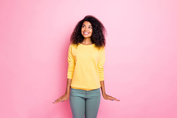 Portrait of charming teen youth african girl have thought think about weekends holidays feel candid enjoy wear yellow sweater pants isolated over pastel color background - Foto, Imagem