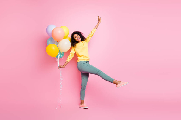 Full length photo of beautiful pretty dreamy lovely careless enjoy love like have good lucky mood holding many baloons in hand walking straight in casual jumper isolated pastel pop color background - Zdjęcie, obraz