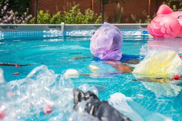 Ecologia, lixo plástico, emergência ambiental e poluição da água - homem desesperado com um saco de plástico sobre a cabeça em uma piscina suja
 - Foto, Imagem