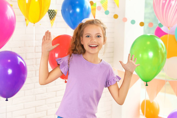 Happy girl near bright balloons at birthday party indoors - Fotografie, Obrázek