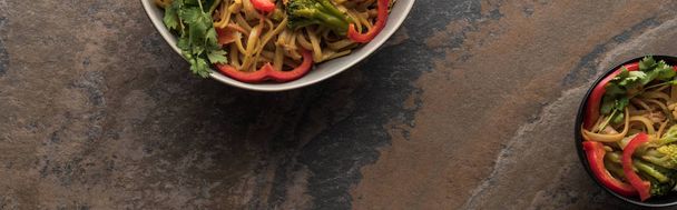 top view of thai noodles near chopsticks on stone surface, panoramic shot - Photo, Image