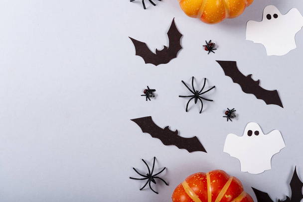 Halloween and decoration concept, Pumpkins, bats, flies, spiders and ghosts on gray background. - Фото, зображення