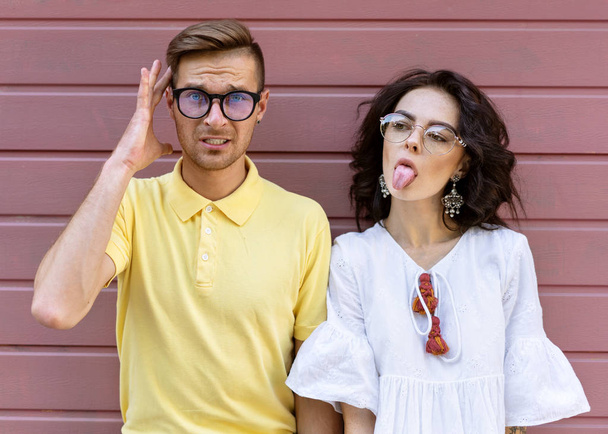 Young fashionable couple on pink background - Foto, immagini