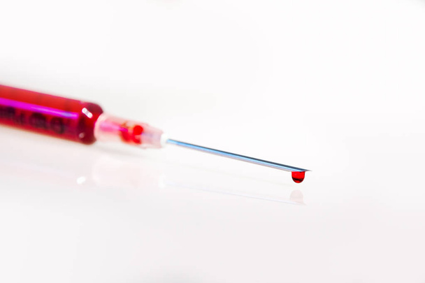 Syringe with blood on white background - Φωτογραφία, εικόνα